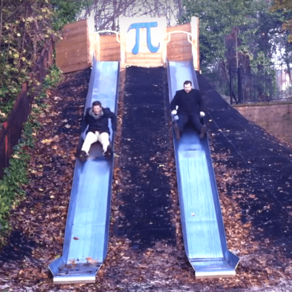 screen grab from the George Green video of Sam and Peter going down a slide in the George Green playground